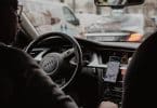 man in black jacket driving car during daytime