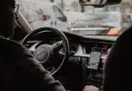 man in black jacket driving car during daytime
